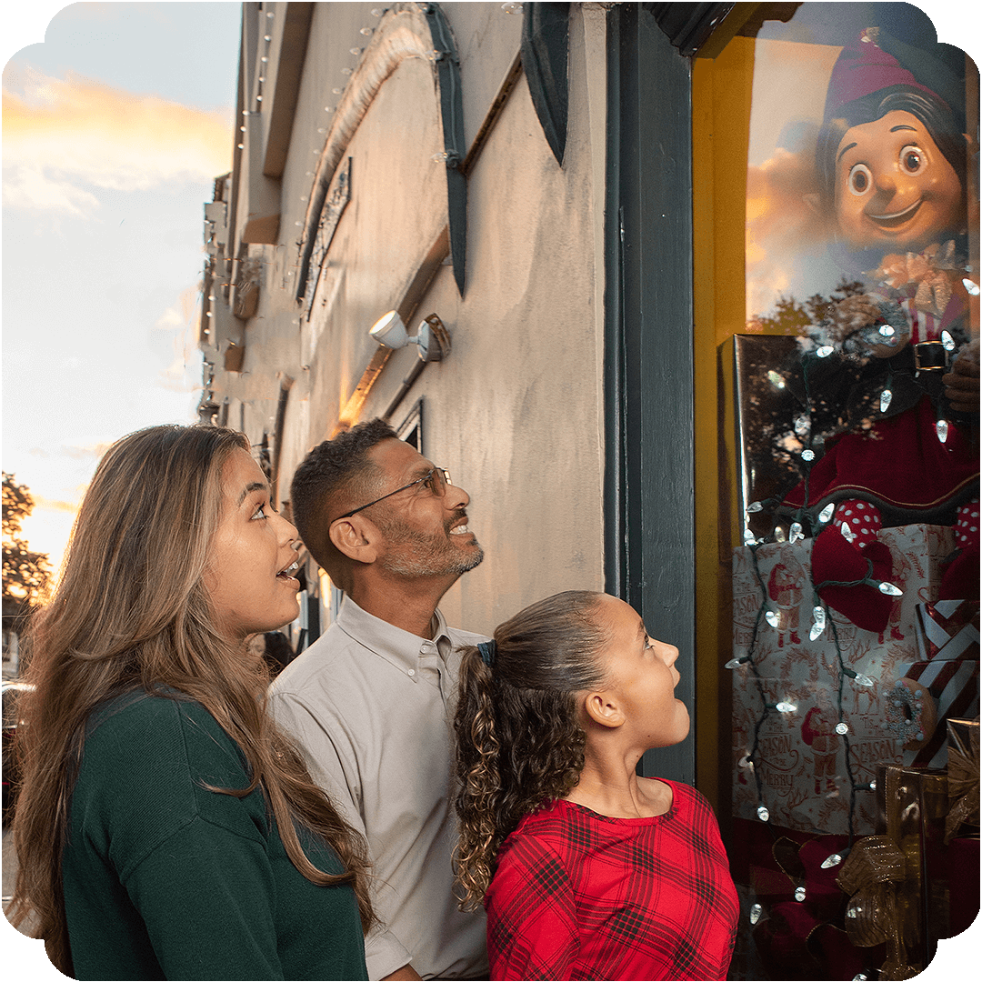 family viewing elf through window